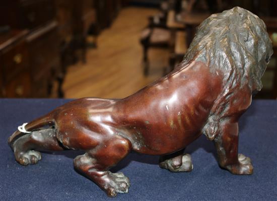 A Japanese brown patinated bronze figure of a roaring lion, Meiji period, length 34cm